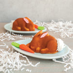 Two plates each holding a single bunny-shaped cake decorated with a small carrot and shredded tail