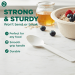 Single white compostable spoon on a marble surface with text claiming strong & sturdy and icons for smooth grip and durability