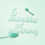 3D-style text reading ‘6 months of brushing’ with toothbrush heads and soft green background in Ordo brand color