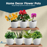 Six white speckled ribbed planters displayed on two wood shelves each holding different flowering or foliage plants with 'Home Decor Flower Pots' header