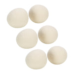 Six off-white felted wool dryer balls shown grouped on a white background