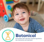 Close-up of a smiling baby on a blurred playroom floor with a botanical icon and text graphic promoting natural ingredients