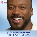 Close-up smiling man showing teeth with Crest 3D White logo and “Safe on teeth and gums” banner