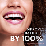 Close cropped smiling mouth with white teeth and overlay text claiming improved gum health against a dark background