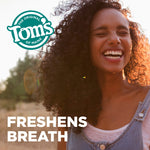 Smiling person outdoors with Tom's of Maine logo in the corner and 'FRESHENS BREATH' headline overlaid on the image.