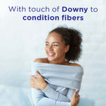 Smiling person wrapped in a sweater beneath headline text "With touch of Downy to condition fibers," a lifestyle image linked to the product.