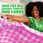 Smiling woman holding a pink checked sheet with overlay text stating product is safe for all colors and fabrics