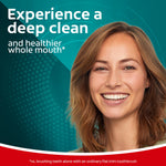 Smiling woman on a teal background with text promoting a deep clean and healthier whole mouth beside her face