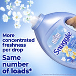 Close-up of angled Snuggle Blue Sparkle bottle pouring floral-scent imagery with text about concentrated freshness