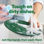 Hands washing a green plate under running water with foam and overlaid text 'Tough on dirty dishes, not the hands that wash them'