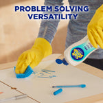 Gloved hand using a sponge to wipe marker off a table while pouring Soft Scrub OXI from a bottle, headline reads 'Problem Solving Versatility'