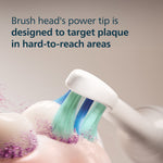 Macro illustration of a Philips Sonicare brush head tip removing plaque from tooth surface