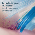 Detailed macro illustration of blue bristles and gum surface with copy about '7x healthier gums in 2 weeks'