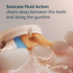 Illustration of a Sonicare brush head engaging teeth and gumline with fluid action graphics and descriptive text.
