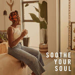 Woman sitting in a sunlit living room holding a mug, lifestyle graphic with text reading “SOOTHE YOUR SOUL”