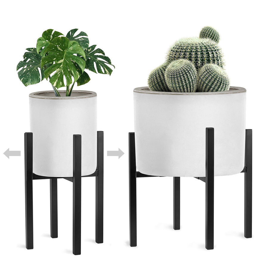 Two black metal mid-century plant stands shown adjusted to different widths holding white planters