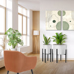Living room scene with two black metal plant stands holding white planters and greenery