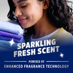 Woman holding a stack of folded towels near her face overlaid with text 'Sparkling Fresh Scent' and fragrance technology callout