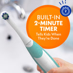 Teal Spinbrush toothbrush held in a hand with an orange circle graphic reading 'Built-in 2-minute timer' over a blurred bathroom background.