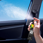 Hand holding a Little Trees Black Ice spray bottle spraying mist inside a vehicle interior near a window