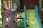 Outdoor playset with a dirty slide and a Spray Nine trigger spray bottle placed on the wooden platform nearby.