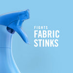 Close-up blue spray trigger on a light blue background with bold text reading 'Fights Fabric Stinks'.