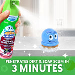 Hand holding and spraying a Scrubbing Bubbles aerosol can toward a small blue scrub brush on a countertop with foam and sparkle accents.