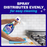 Close scene of someone spraying Mr. Clean Clean Freak Kitchen product onto a dirty countertop while wiping with a blue cloth