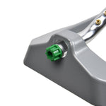Close detail of a gray sprinkler base showing a green plastic hose connector and metal spray tube.