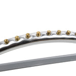 Close-up of the sprinkler's arched metal spray bar with a row of brass nozzle tips against white background.