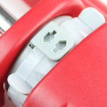 Close-up detail of a red sprinkler housing showing a gray plastic adjustment or locking mechanism for the oscillation