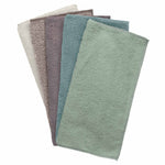 Five assorted-color microfiber cleaning cloths fanned out showing texture in muted green, blue, gray and taupe tones