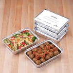 Stacked Handi-foil aluminum meal prep pans with lids beside two open pans filled with rice-vegetable mix and meatballs.