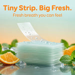 Stack of translucent breath strips with water droplets, mint leaves and orange slice, headline 'Tiny Strip. Big Fresh.'