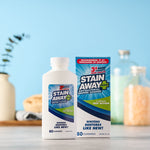 Stain Away Plus bottle and matching product box displayed together on a tabletop with blurred background