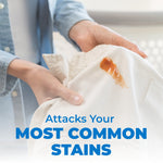 Close-up lifestyle image of hands holding a stained white shirt with overlay text 'Attacks Your Most Common Stains'.