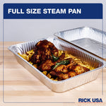 Two full-size aluminum steam pans on a wood surface, one filled with roasted chicken and fries and one empty behind, branded RICK USA