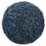 Close-up top view of a round blue-gray steel wool soap pad showing fibrous texture and soap residue