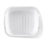 Top-down view into a white Sterilite dishpan showing internal ribbed base texture and rounded corners