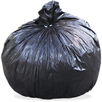 Large tied black trash bag filled and knotted at top on white background
