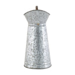 Straight-on view of a tapered galvanized pitcher showing textured metal and flared spout