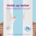 Close-up comparison of two stretched tissues with 'Holds up better than regular tissues' headline and Puffs logo
