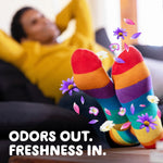 Relaxing scene of colorful striped socks with floral scent graphics and text 'odors out. freshness in.'