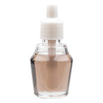 Studio shot of a clear glass fragrance oil bottle with white plastic cap and pale amber liquid on a white background.