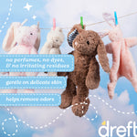 Four plush stuffed bunnies hanging on a clothesline against a cloudy sky with Dreft benefit callouts in blue panels