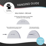 Instructional hanging guide graphic showing how to use a pre-drilled slot in a circular wall plaque for hardware-free hanging