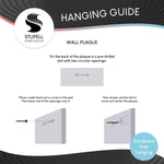 Hanging guide infographic explaining how to use the pre-drilled slot on a wall plaque with illustrations
