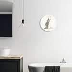 Bathroom scene with a round raccoon-and-toilet-paper wall plaque hung above a bathtub