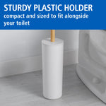 White plastic toilet brush holder with a bamboo handle placed on a bathroom floor next to a toilet, 'Sturdy Plastic Holder' header above.