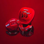 Styled group shot on red background showing Shock Doctor lip guard, case and strap all decorated with Kool‑Aid graphics.